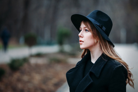 Outdoor portrait of a romantic, pretty elegant business of a long-haired woman, enjoying a stroll...