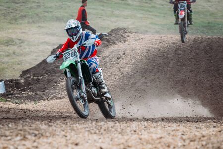 Lebedyanka, Russia - August 25, 2019: Russian Motocross Championship, motocross racer accelerating in dirt trackのeditorial素材