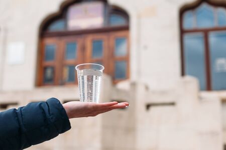 Yessentuki, Stavropol Territory / Russia - February 26, 2019: Drinking gallery of mineral spring Essentuki â 17. young woman holding a glass of mineral waterのeditorial素材
