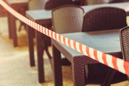 stretched security tape at tables in a street cafeの写真素材