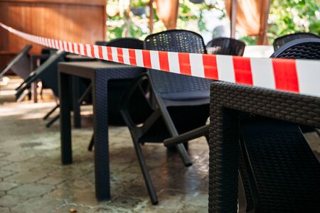 stretched security tape at tables in a street cafeの写真素材