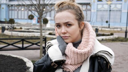 young beautiful blonde woman outdoors a toothache. outdoors.の写真素材