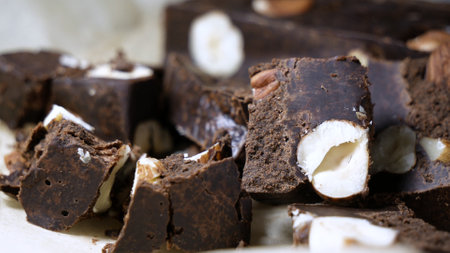 Chocolate bar with whole hazel nuts tasty dessert close up.