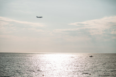 plane in the sky over the seaの写真素材