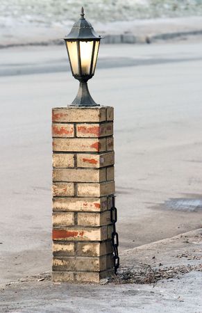 old-fashioned lamp on the brick postの写真素材