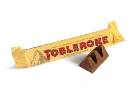 Chisinau, Moldova - June 14, 2016: A bar of Toblerone - Swiss milk chocolate with honey and almond nougat on a white background. With clipping path.のeditorial素材