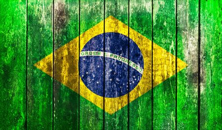 Flag of Brazil painted on grungy wooden plank backgroundの写真素材