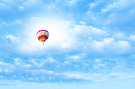 Hot air balloon flying in a blue skyの写真素材