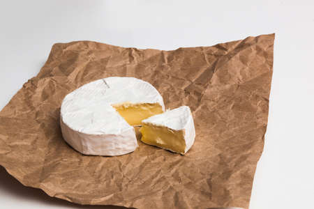 Fresh slice Camembert cheese natural, on Kraft paperの写真素材
