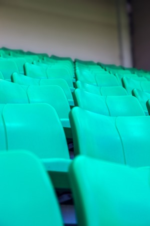 Green plastic seats at stadium in perspectiveの写真素材