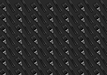 Many transparent plastic forks  on gray background, top view. Disposable table wear concept. Creative top view pattern.の写真素材