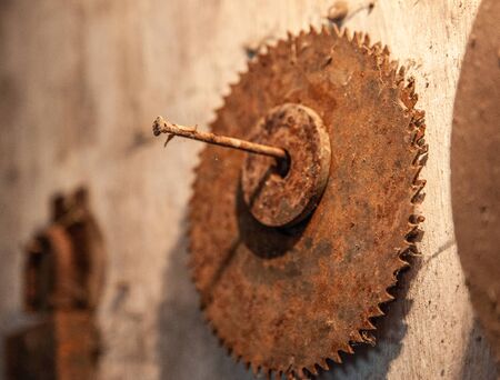 Old rusty circular saw a wall background. Close upの写真素材