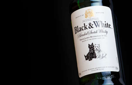 CHISINAU, MOLDOVA - APRIL 27, 2020: Black and White blended Scotch Whisky bottle label closeup on...