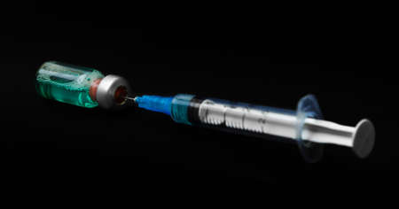 syringe isolated on black background