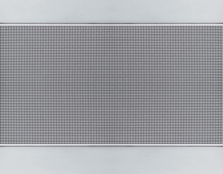Spot lit perforated metal plate. Metal background close-upの写真素材