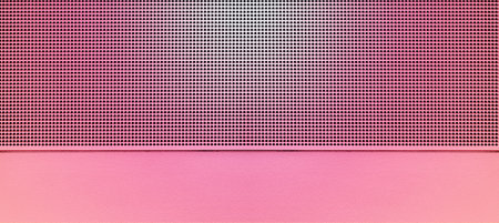 Spot lit perforated pink metal plate. Metal background close-upの写真素材