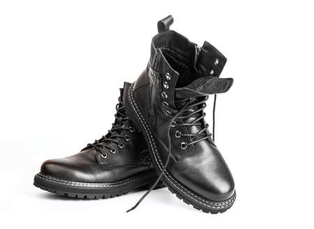 Black boots isolated on white. Steel cap leather boots isolated on white. Black combat men boot,...