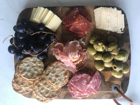 Simple, fancy Charcuterie board with meats and cheesesの写真素材