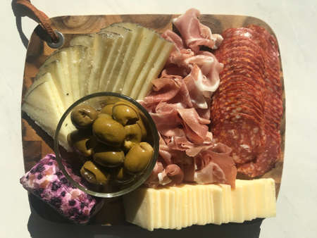 Beautiful Charcuterie Board with Delightful Meats, Cheeses, and Olivesの写真素材