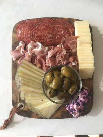 Beautiful Charcuterie Board with Delightful Meats, Cheeses, and Olivesの写真素材