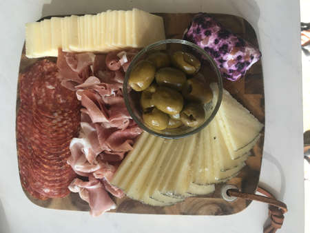 Beautiful Charcuterie Board with Delightful Meats, Cheeses, and Olivesの写真素材