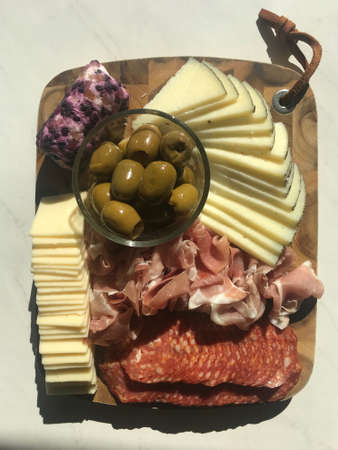 Beautiful Charcuterie Board with Delightful Meats, Cheeses, and Olivesの写真素材