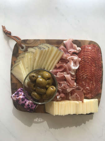 Beautiful Charcuterie Board with Delightful Meats, Cheeses, and Olivesの写真素材