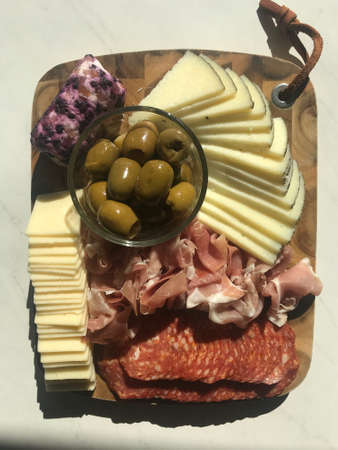 Beautiful Charcuterie Board with Delightful Meats, Cheeses, and Olivesの写真素材