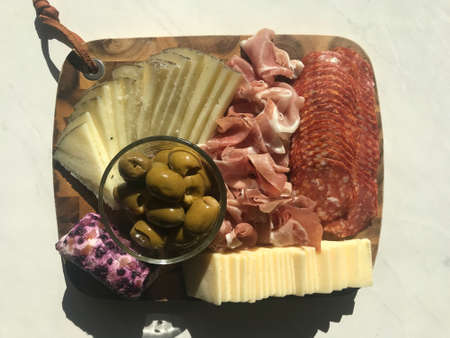 Beautiful Charcuterie Board with Delightful Meats, Cheeses, and Olivesの写真素材