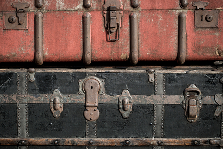 Old vintage antique suitcases trunks in a stack backgroundの写真素材