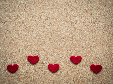 Red hearts on cork board.の写真素材