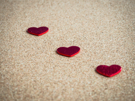 Red hearts on cork board.の写真素材