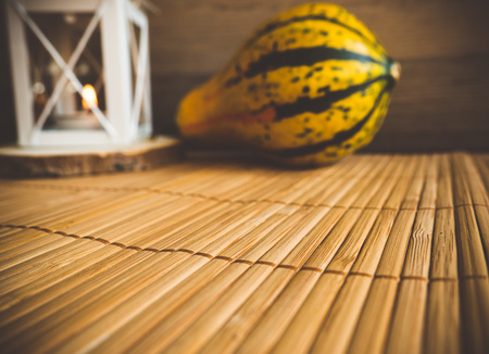 Decorative pumpkin and a lantern on a wooden background.の写真素材