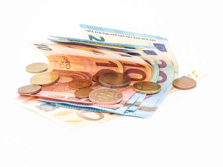 Close-up of Euro money, euro coins and euro banknotes on white background