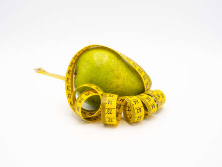 Yellow measuring meter round green pear on a white background close up, body shapeの写真素材
