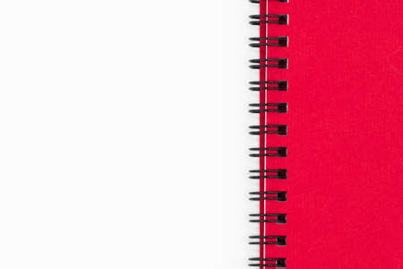 Close up of spiral notebook or notepad with red cover isolated on white backgroundの写真素材