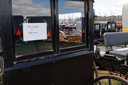 GORDONVILLE PENNSYLVANIA - March 11, 2017: Amish carriages for sale at annual spring auction `Amish Mud Sale` to benefit the Fire Company. Sale items include quilts, antiques, crafts, food, sporting goods, tools, farm equipment, and horses.のeditorial素材