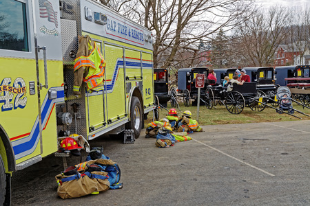 GAP PENNSYLVANIA - MARCH 25, 2017: Fire Engines  and Amish Carriages parked side by side at the...