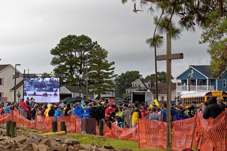 CHINCOTEAGUE, VIRGINIA - JULY 25, 2018: The crowd waits in rainy weather for the Chincoteague Wild Pony Swim. This is an annual event to raise money for the  Volunteer Fire Company.のeditorial素材