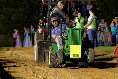 MYERSTOWN, PENNSYLVANIA - SEPTEMBER 14, 2018: A man drives a modified lawn tractor at Myerstown East End Days. The tractor pull is an annual community event.のeditorial素材
