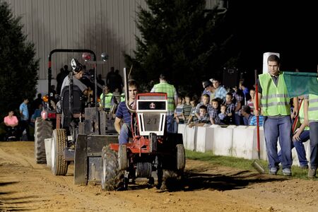 MYERSTOWN, PENNSYLVANIA - SEPTEMBER 14, 2018: A young boy drives a modified lawn tractor at Myerstown East End Days. The tractor pull is an annual community event.のeditorial素材
