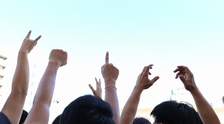 community initiative or concert concept, hands of group of people in the skyの写真素材