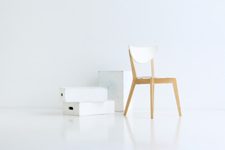 Wood chair on white background with white wood boxes and soft reflection on the floorの写真素材