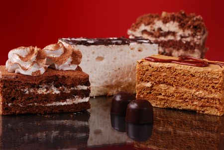 Appetizing cakes and sweets on red backgroundの写真素材