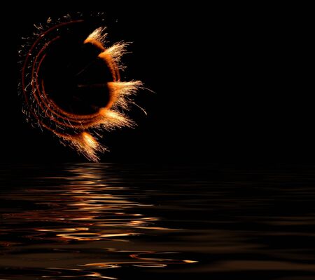 The fireworks show with a reflection on the waterの写真素材