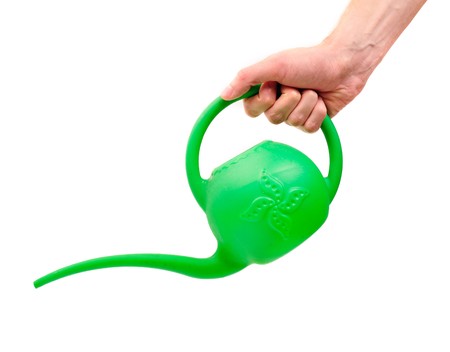 Man's hand with watering can isolated on white の写真素材