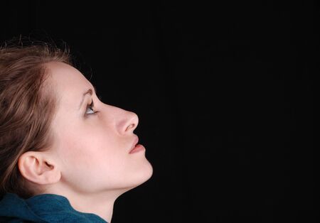 beautiful feminine profile face on black backgroundの写真素材