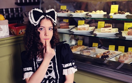 Young beautiful woman with cakes in cafe. の写真素材