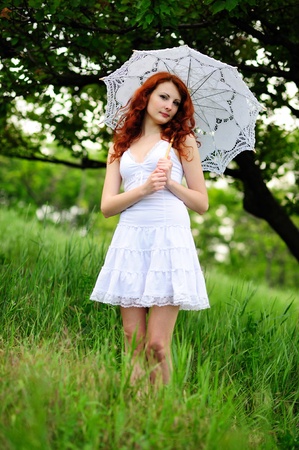 Happy girl portrait, walking with umbrella in park  Outdoor  の写真素材