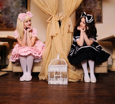 Young women dressed as dolls look at each other.の写真素材